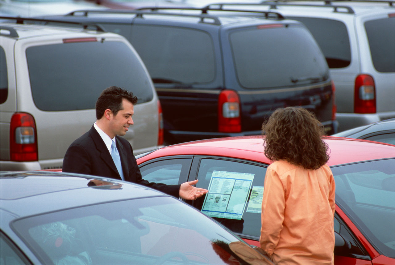 woman being showed a used car