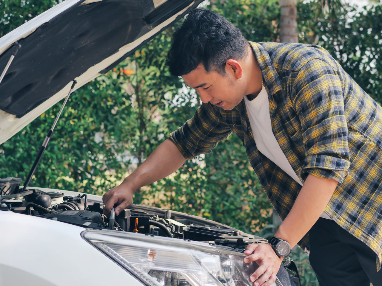 Asian man open car hood and check up his car, lifestyle concept.