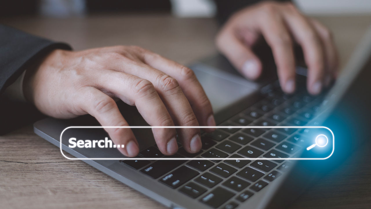 People hand using laptop or computor searching for information in internet online society web with search box icon and copyspace.