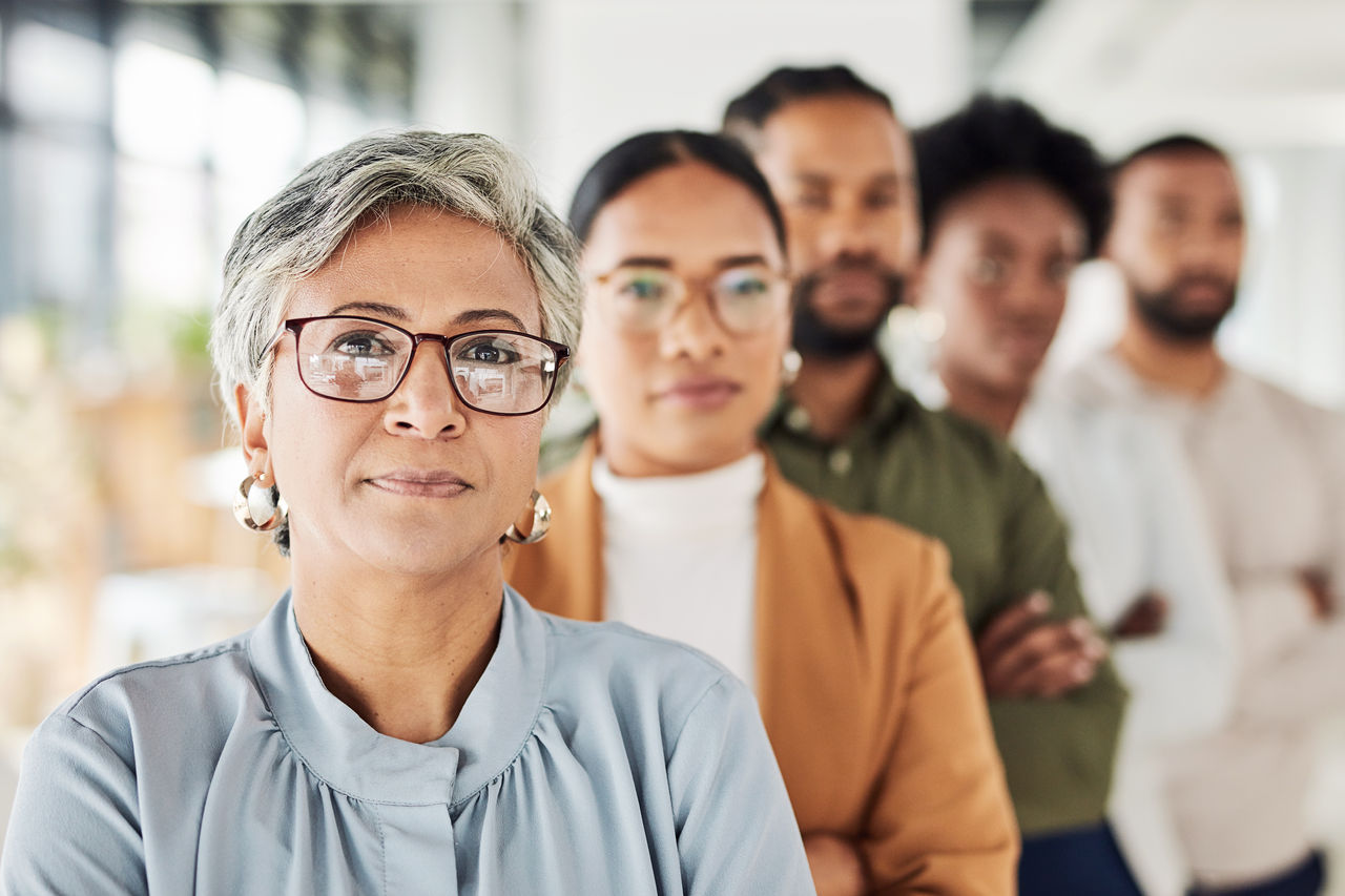 Portrait, business people and team collaboration in office for vision, mission and proud partnership. Leader, collaboration and teamwork by empowered colleagues with idea, mindset and company goal