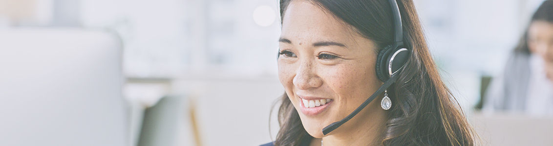 Woman, smile on computer and call center communication, customer service or e commerce support in office. Professional advisor, virtual assistant or Asian consultant for contact us and business FAQ