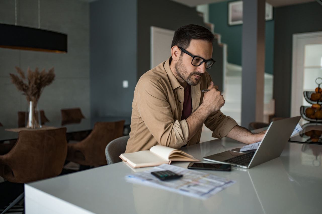Man with laptop doing his taxes