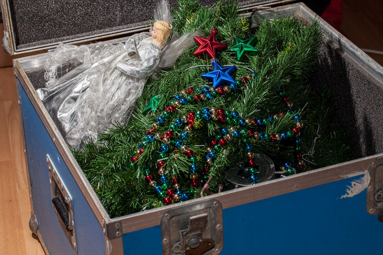 Christmas tree decorations taken down and packed away in storage. End or start of the Xmas holiday. Packing and unpacking the fake Christmas tree, fairy and baubles.