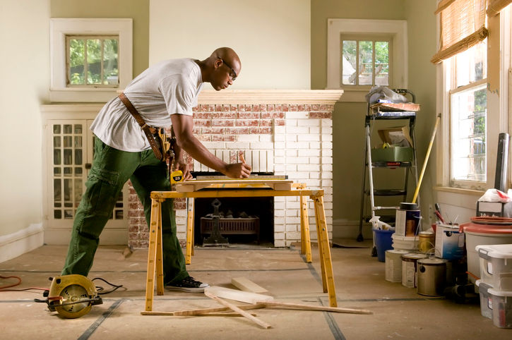 contractor cutting wood in house