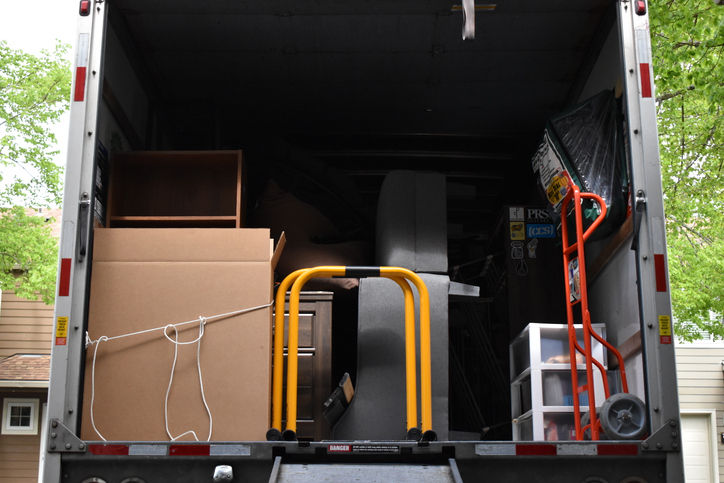 A moving van packed with furniture and belongings