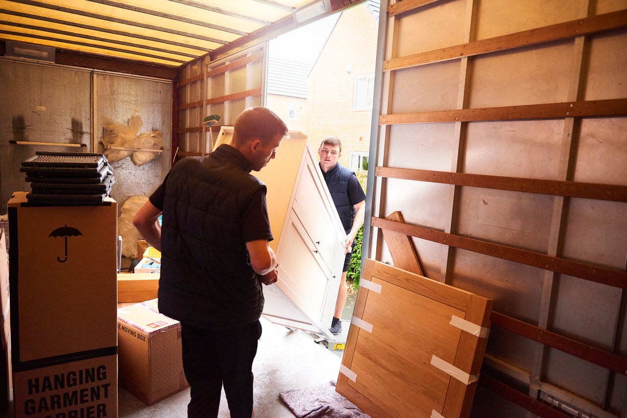 movers moving furniture into moving truck