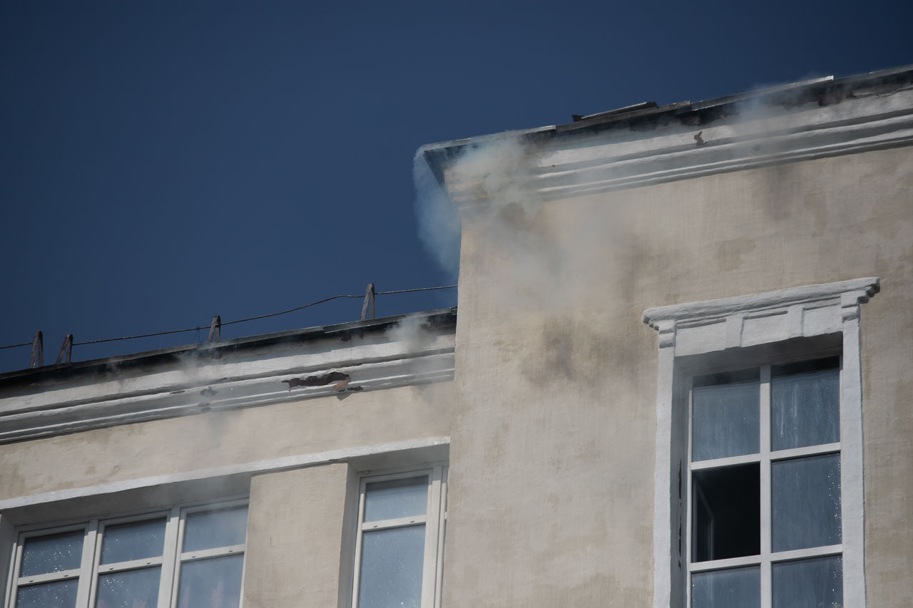 firefighters extinguish a burning residential building