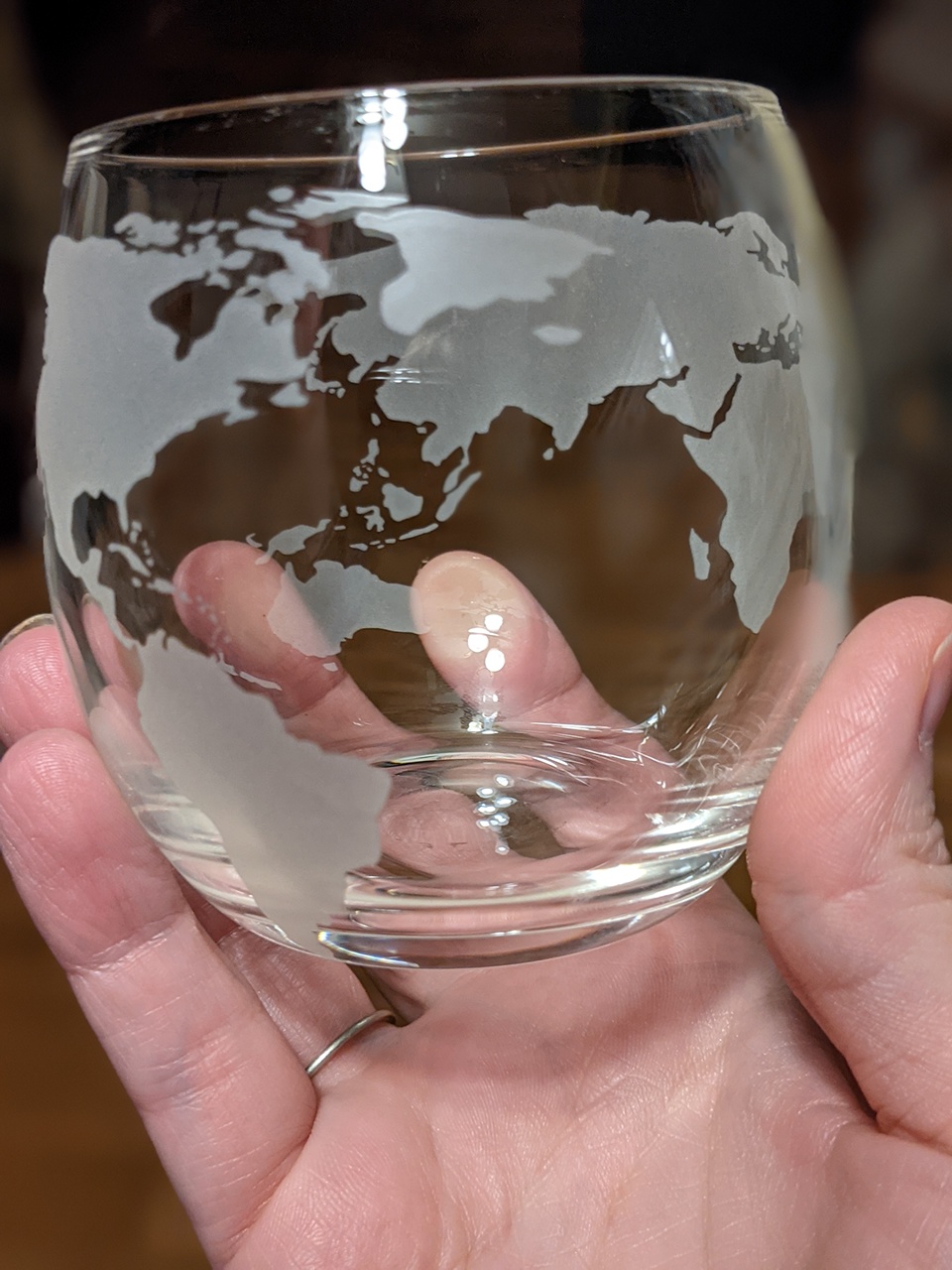 Cup with a world etched on it
