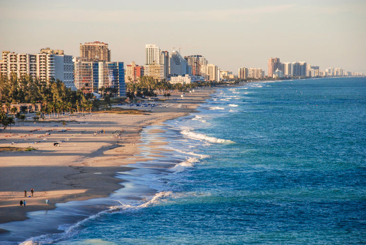 The sun is setting over the Fort Lauderdale, Florida coastline.