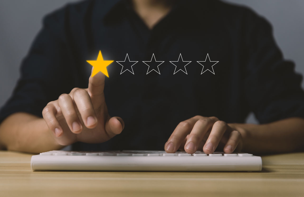 picture of man on laptop with review stars superimposed across image