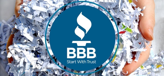 Person holding shredded paper with a BBB logo overlay 