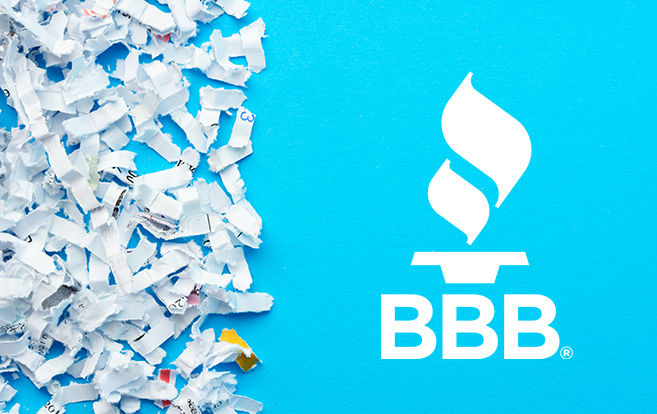 Person holding shredded paper with a BBB logo overlay 