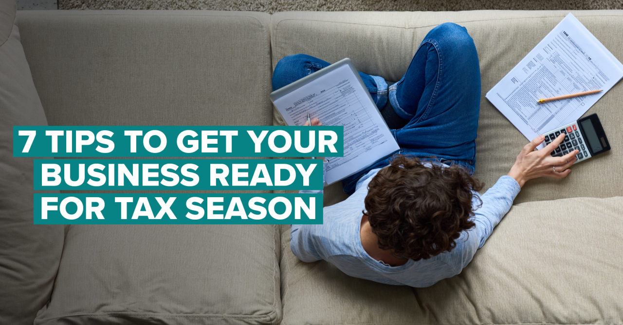 person working on taxes on couch