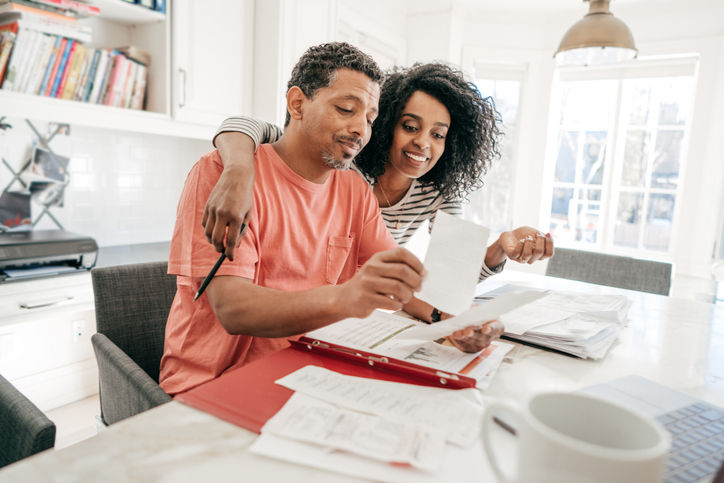 Couple and their financial planning in the kitchen with laptop
