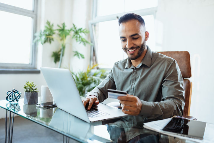 Mid adult Latin businessman in office, working on laptop