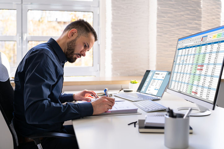 Analyst Working With Spreadsheet On Computer Screen