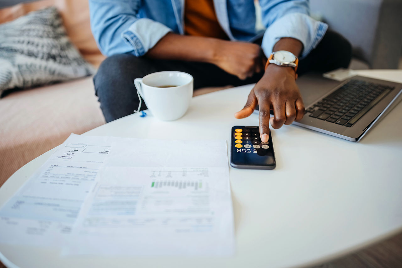 man going over his finances and using a calculator