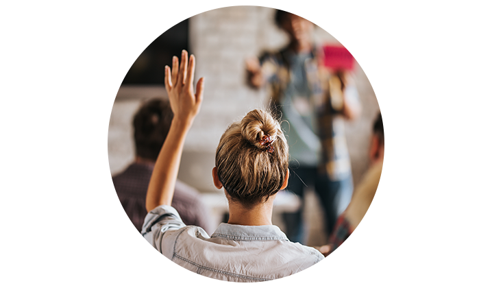 Closeup shot of woman raising hand from the back