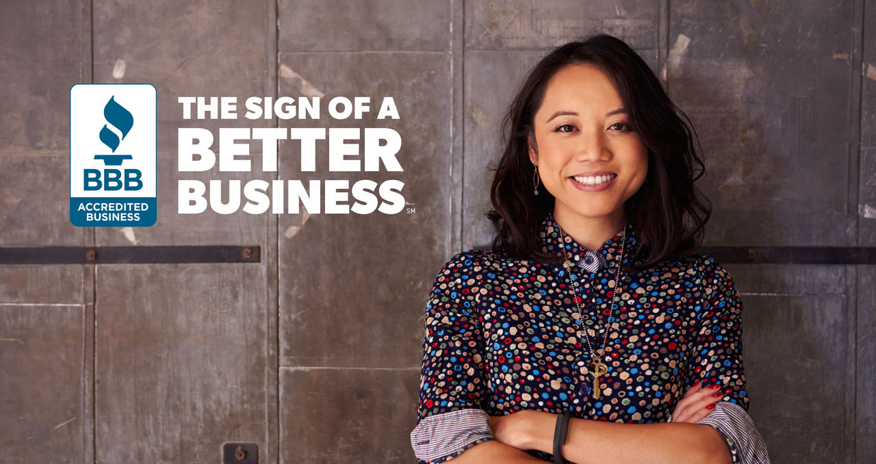 Female business owner with BBB seal and The Sign of a Better Business in white letters