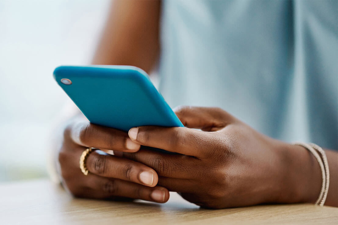 african american woman holding smart phone