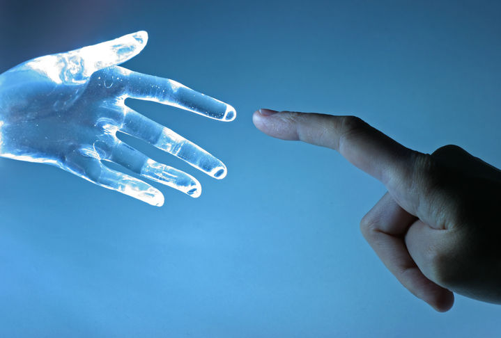 Human hand touch an atrifical glass hand