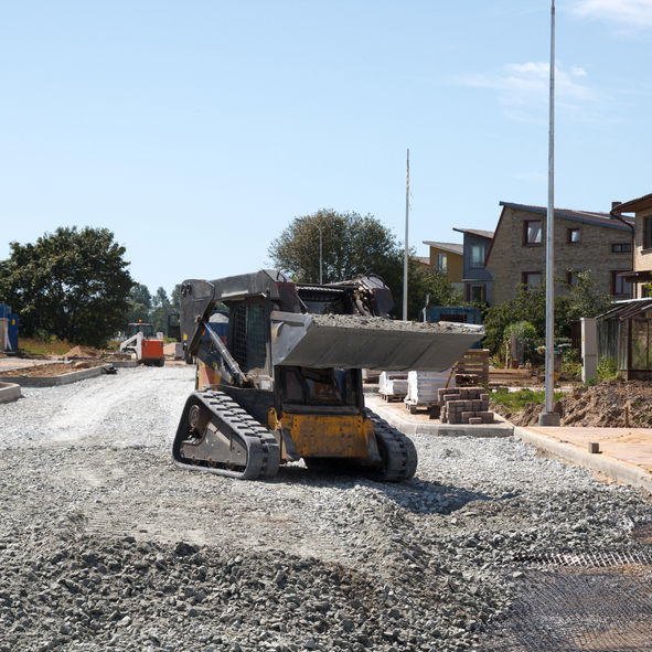 construction of a new street. mini excavator bobcat mowing breakstone