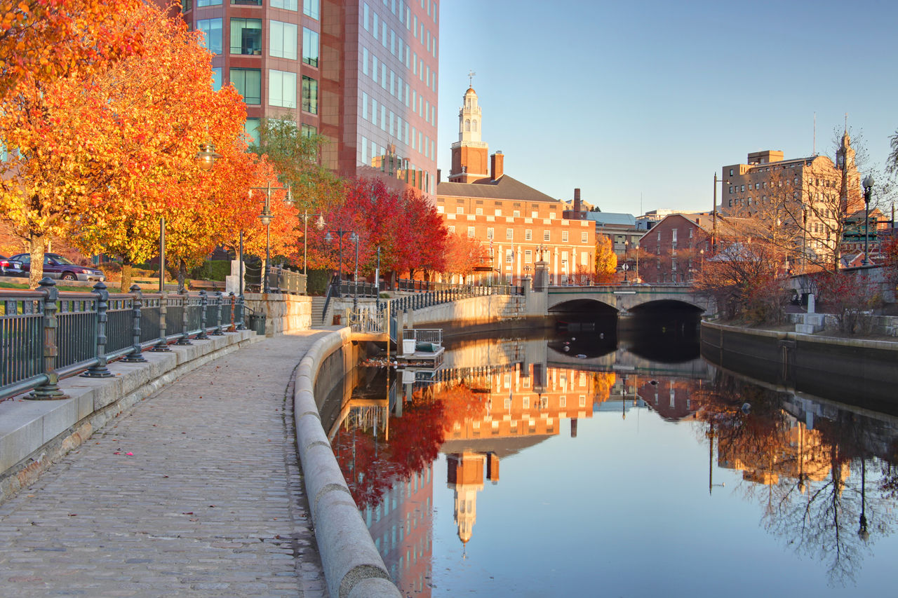 Buildings relfecting on a canal from Waterfront Park in Providence,Rhode Island .Providence is the capital and most populous city in Rhode Island.  Downtown Providence has numerous 19th-century mercantile buildings in the Federal and Victorian architectural styles. Providence is known for its nationally renowned restuarants,great museums, and galleries