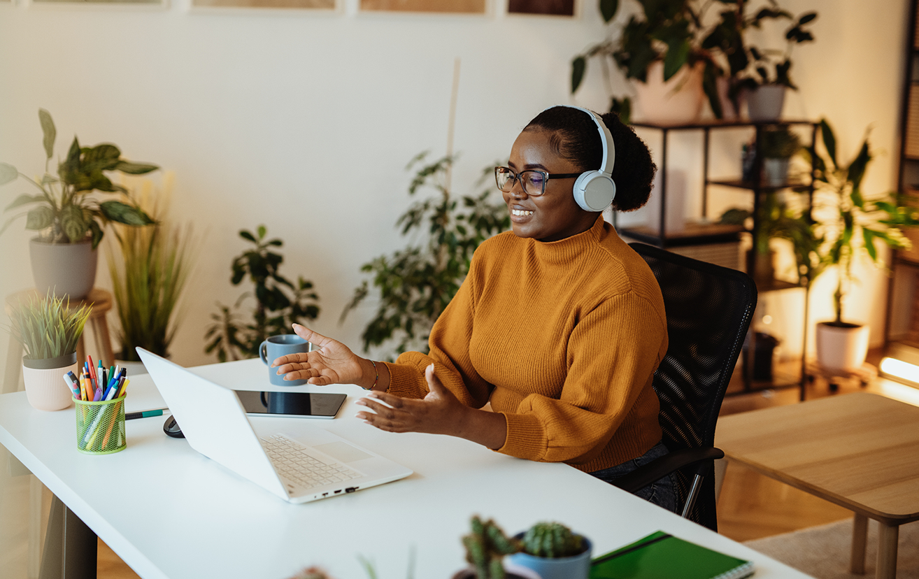 Woman sitting at desk watching laptop