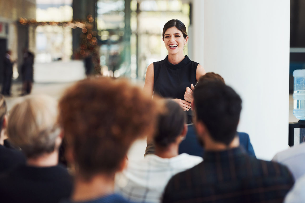 woman speaking to a group in a classroom setting