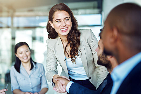 smiling people shaking hands