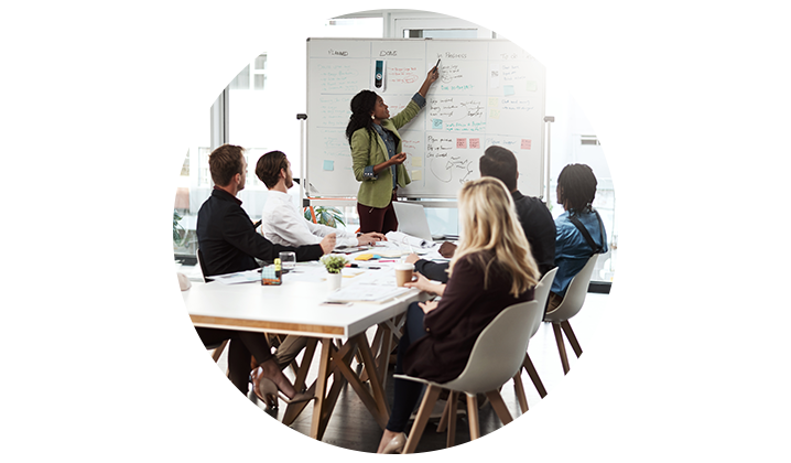 small group of business professionals looking at white board