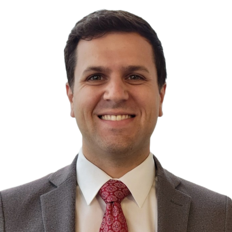 Headshot, smiling man with short dark brown hair in a brown suit and red tie