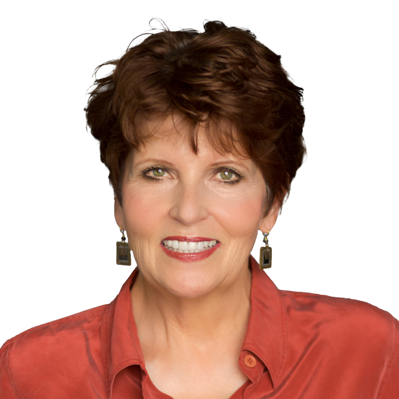 Smiling woman with short red hair, green eyes in a dark orange button down shirt
