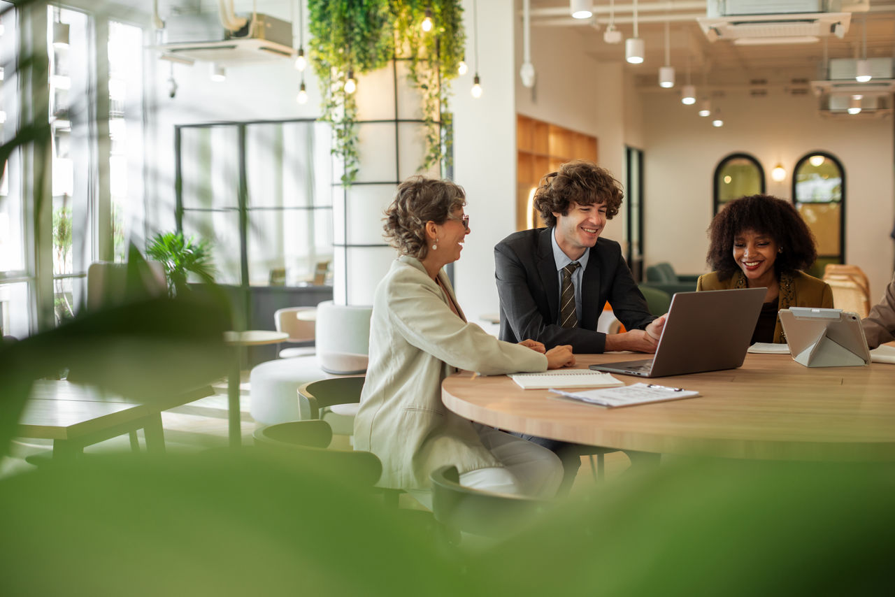 A group of business people is holding a meeting in the open-space office.