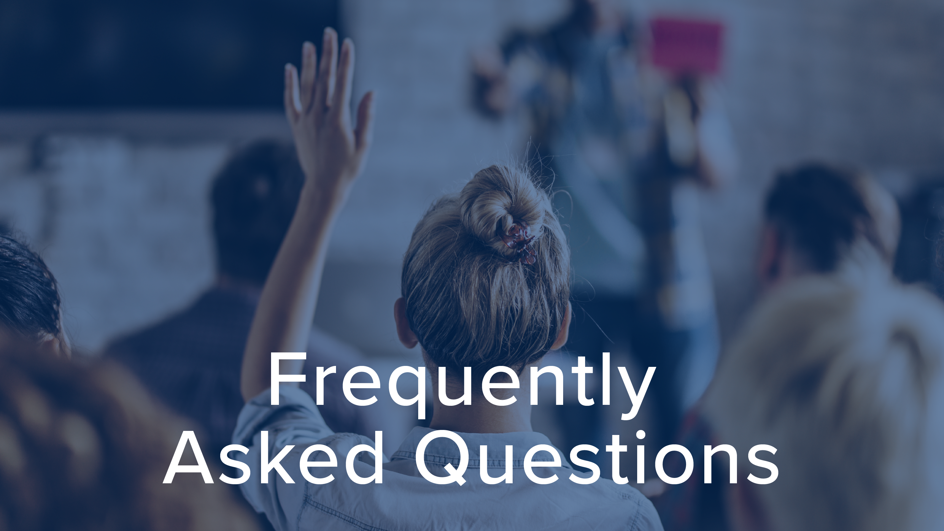 Woman with her hand up to ask a question