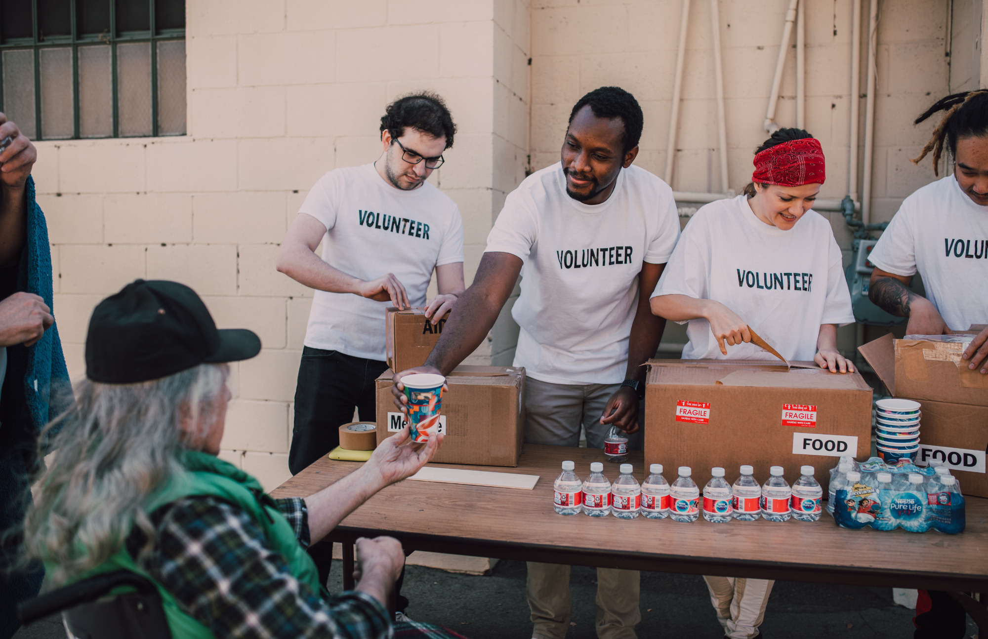 Volunteers handing out water and supplies