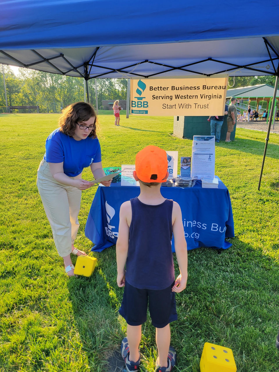 BBB Serving Western VA's Community Outreach and Marketing Support Specialist Riley Ginger works the BBB booth at the Summer Learning Kickoff Event put on by the Botetourt County libraries.