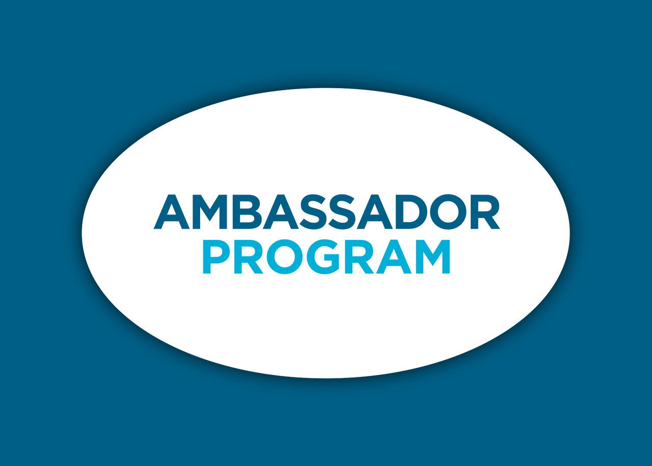 Woman speaking in front of group of people at event