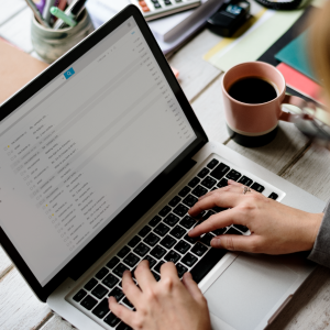 Laptop open with hands typing