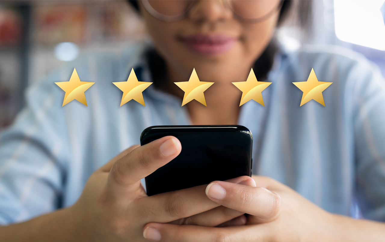 Woman using cell phone with 5 gold star customer satisfaction graphic - stock photo