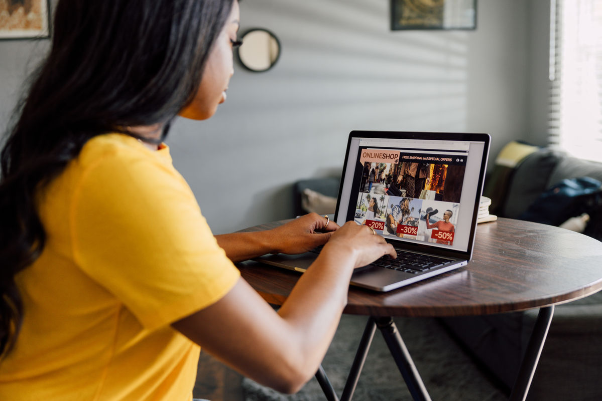Woman using a laptop computer buying online from home.