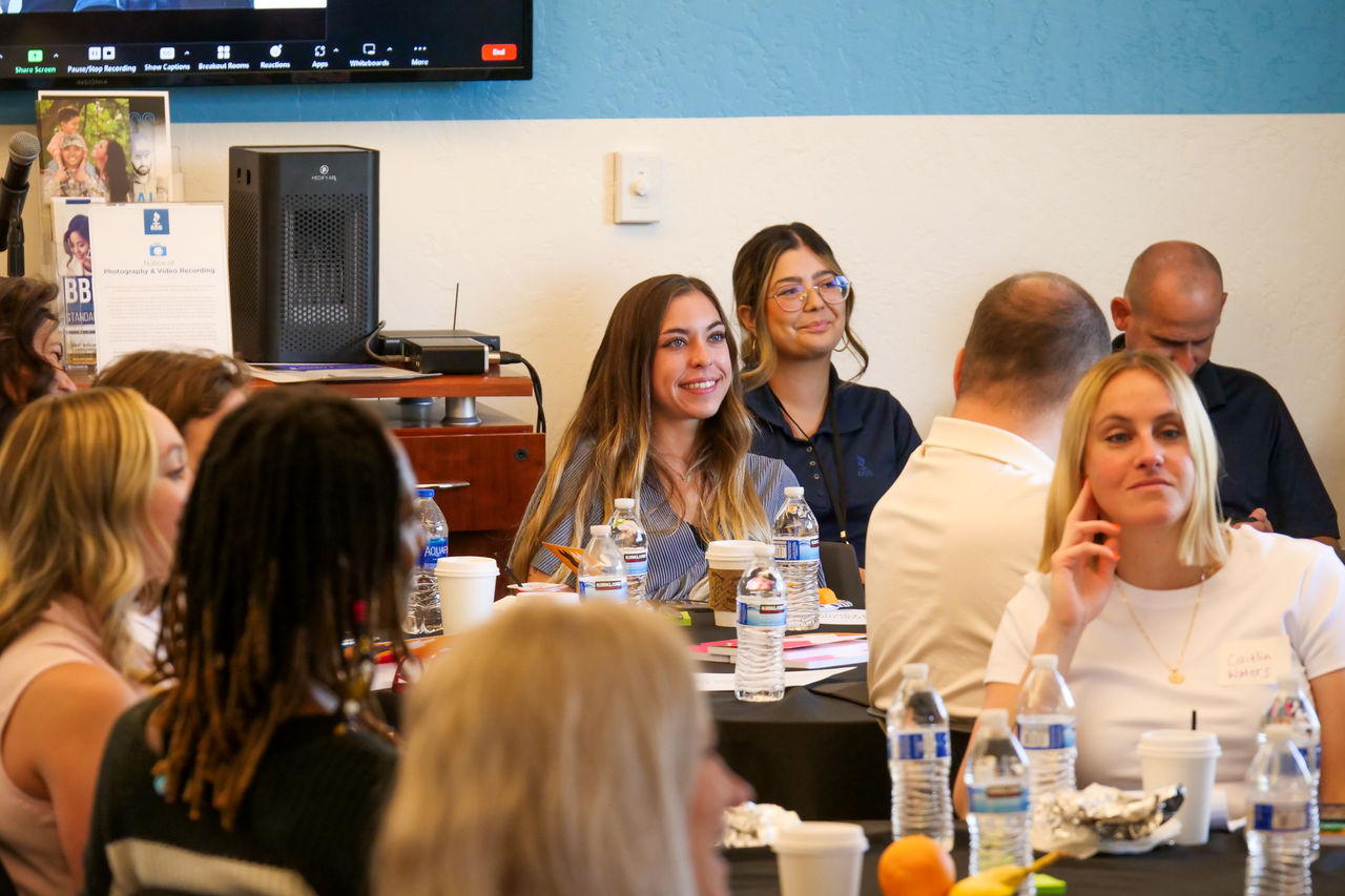 an audience of people listening to a speaker