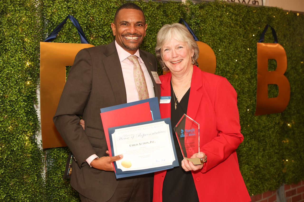 BBB's CEO Lynn Conner posing with a representative from Child Action Inc.