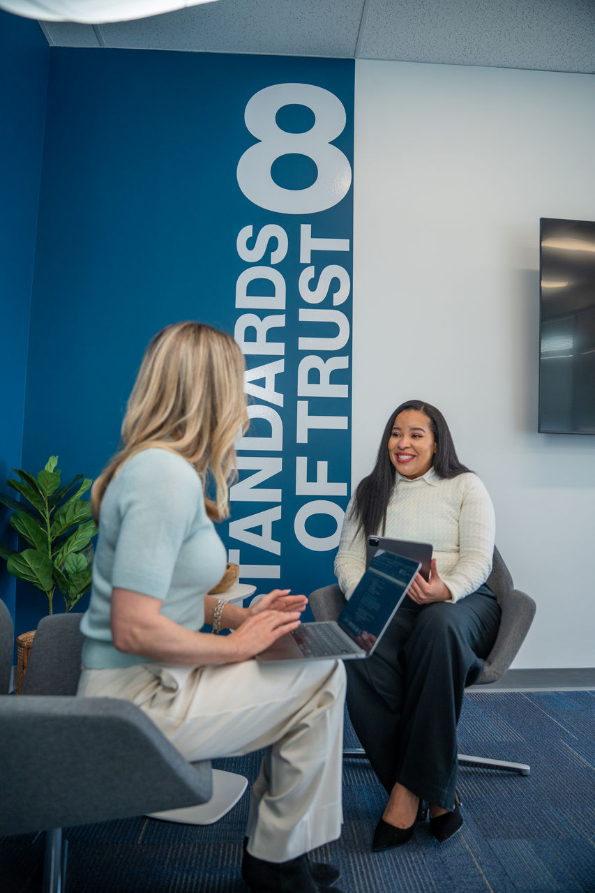 Two ladies talking and looking at a computer