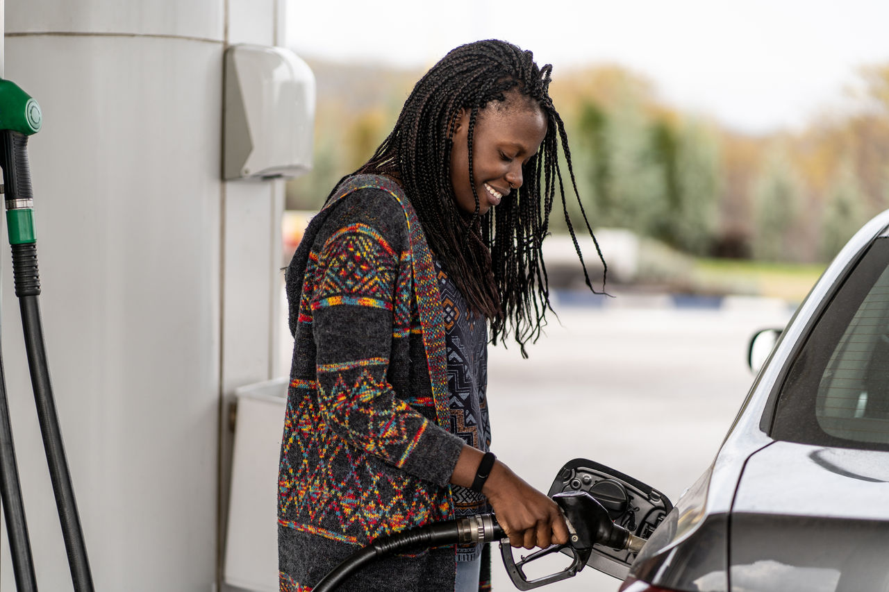 Woman at the gas station refueling car