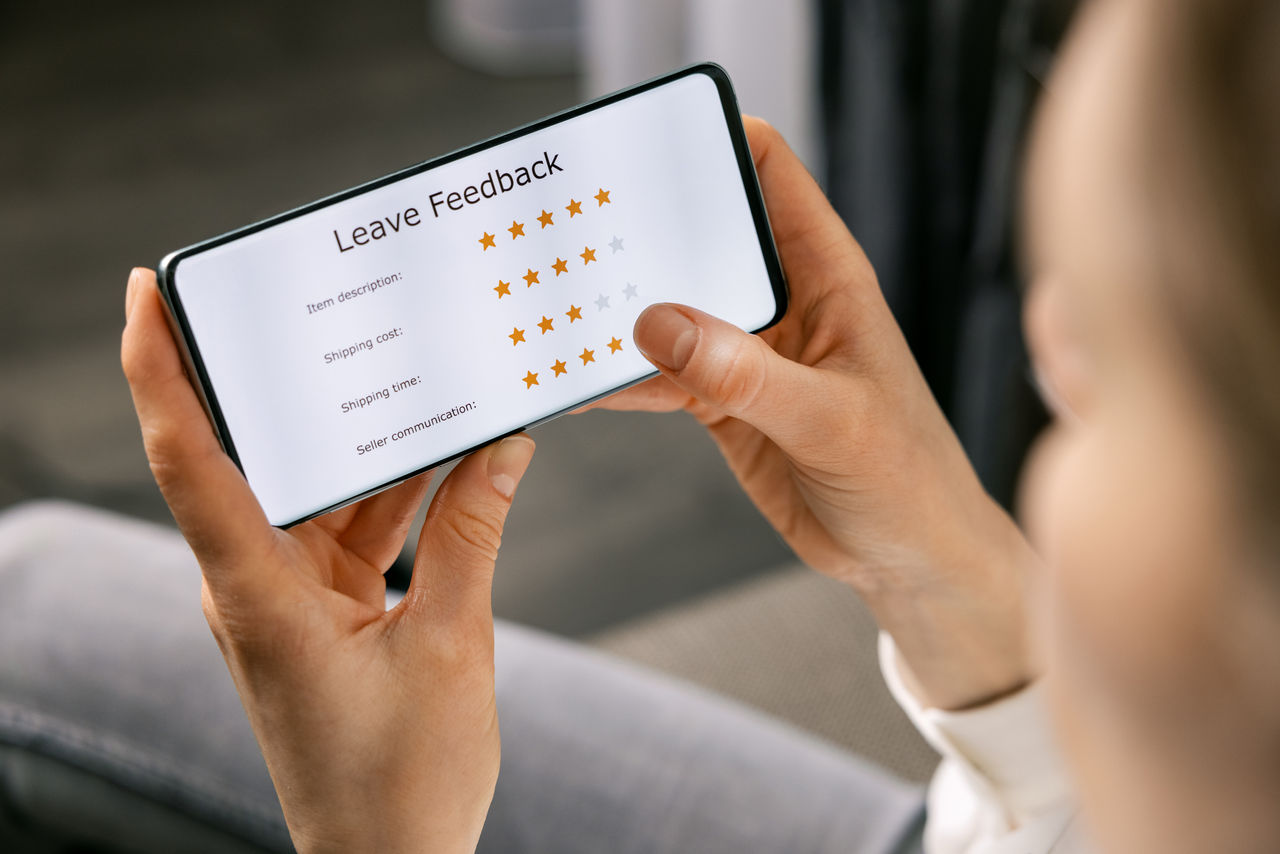 person leaving star rating on smartphone