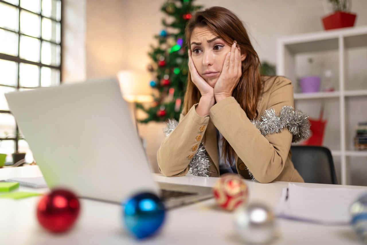 Photo of sad businesswoman working at her home for Christmas holidays