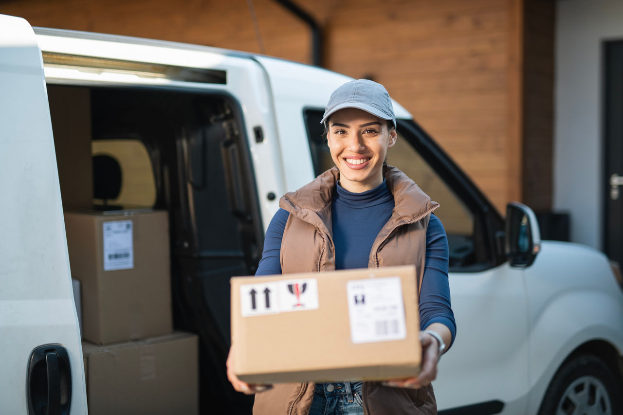 Portrait of a female delivery worker at the delivery address.