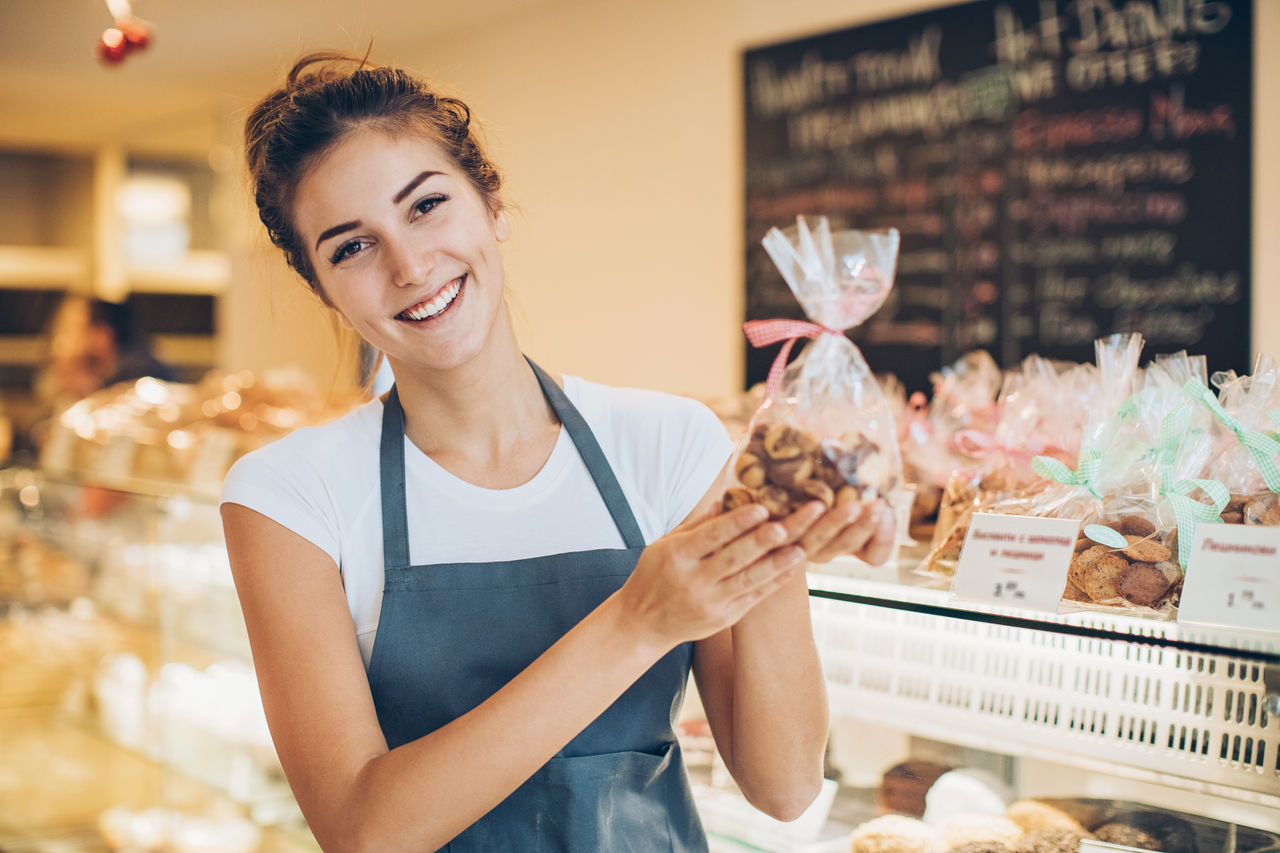 Bakery owner holding package of cookies
