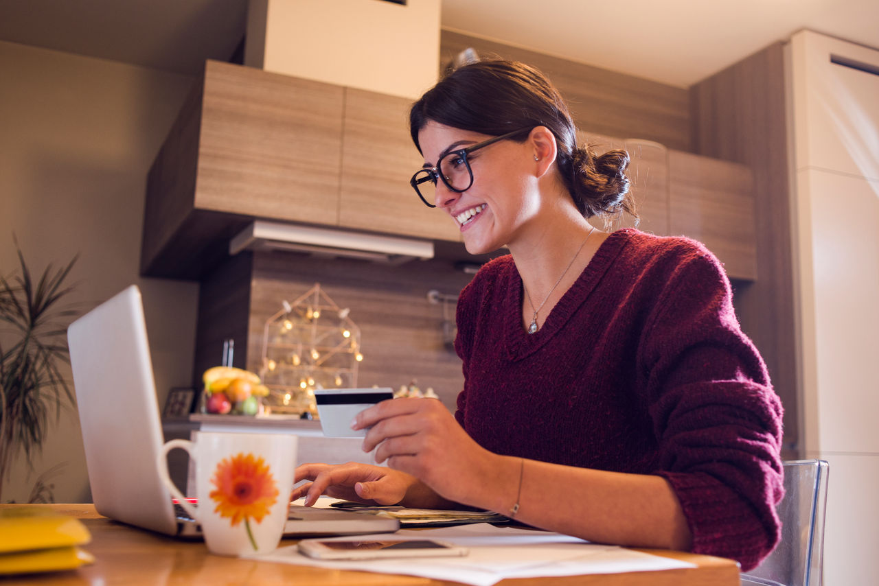 beautiful woman enjoying at home shopping online